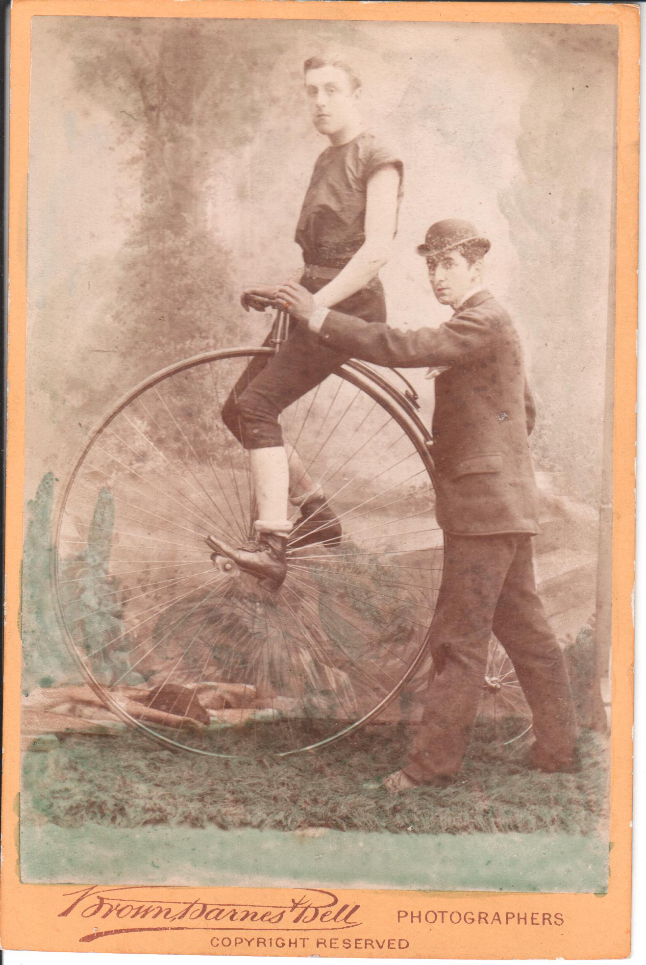 Racing cyclist and his "Starter" Circa 1883